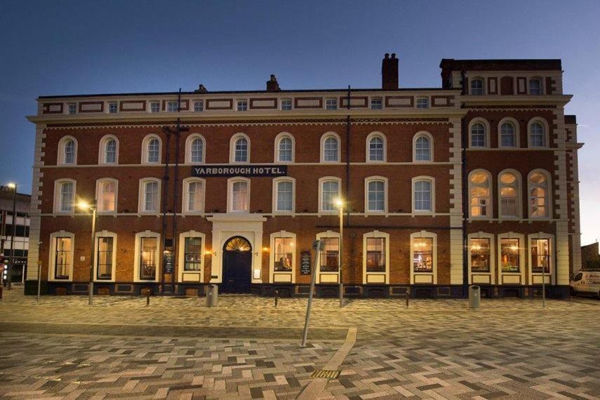 a large brick building with lights in front of it at The Yarborough Hotel Wetherspoon in Grimsby