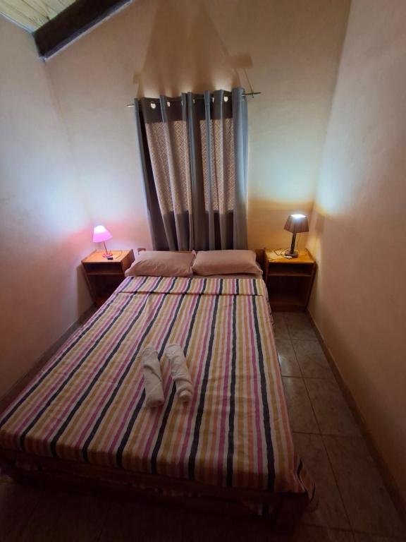 a bedroom with a bed with two slippers on it at Su Escapada Perfecta in Ruiz de Montoya