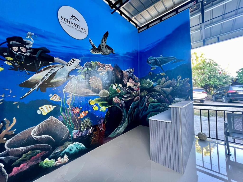 a wall mural of an aquarium in a building at Sebastian Guest House in Moalboal