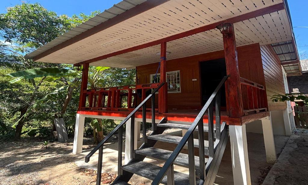 a small house with stairs leading up to it at Duangkeaw Simple House in Phra Ae beach