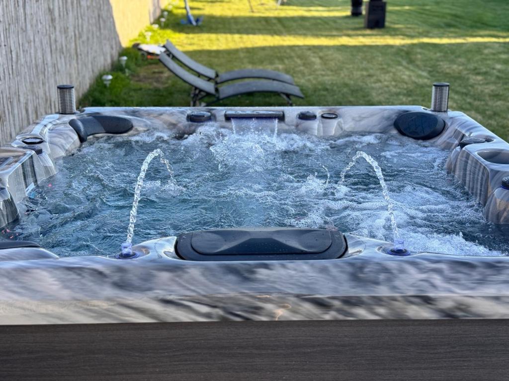 a hot tub with water coming out of it at CASA ELLA in Murighiol