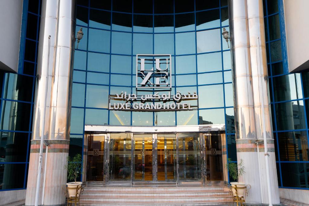 a building with a sign on the side of it at Luxe Grand Hotel in Dubai