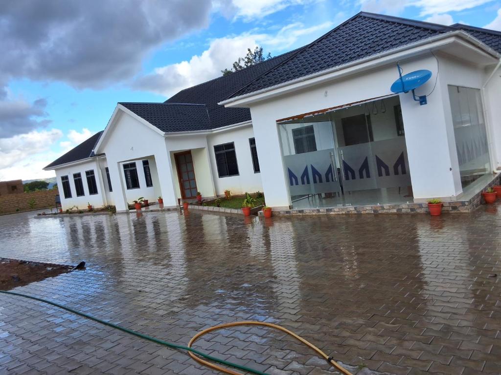 a house is surrounded by water in front of it at Yigs Motel in Iringa