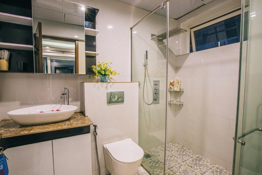 a bathroom with a sink and a toilet and a shower at Happy Villa in Sầm Sơn