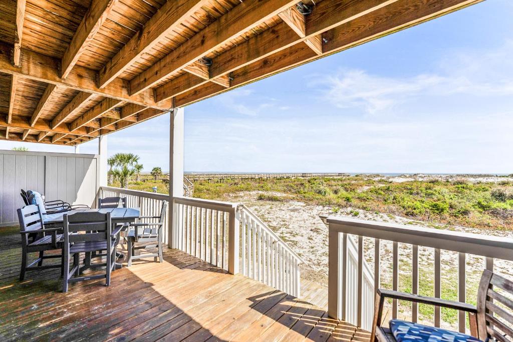 a deck with a table and chairs and a view of the beach at Oceanfront St Helena Island Condo w/ Beach Access! in Oceanmarsh Subdivision