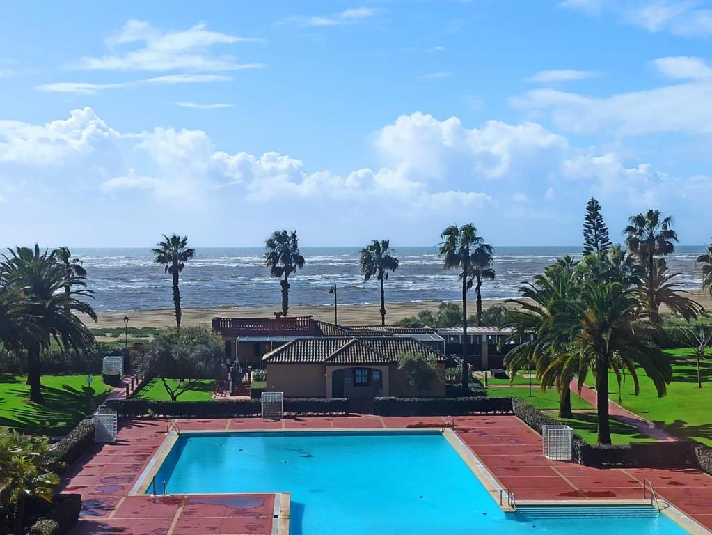 a swimming pool with the ocean in the background at ALCAUDÓN By SIT ISLA CANELA -REF 282- in Ayamonte
