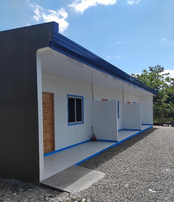 a large white building with a large doorway at Juliet's Homestay in Moalboal
