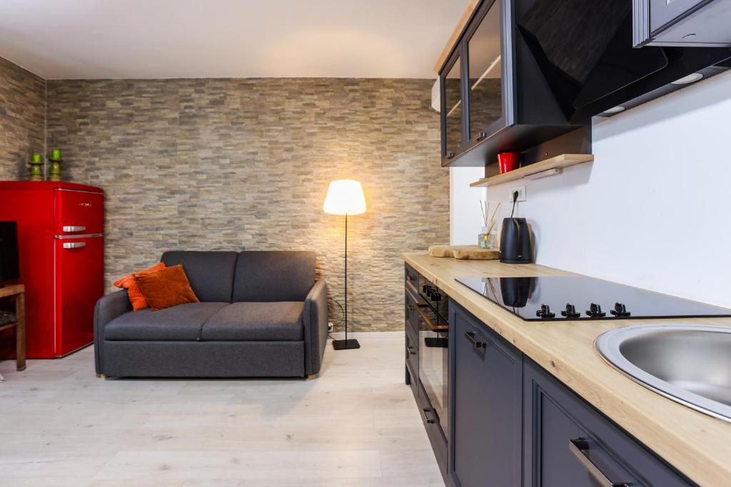 a living room with a couch in a kitchen at Boutique Suite 02 Chic in Zadar