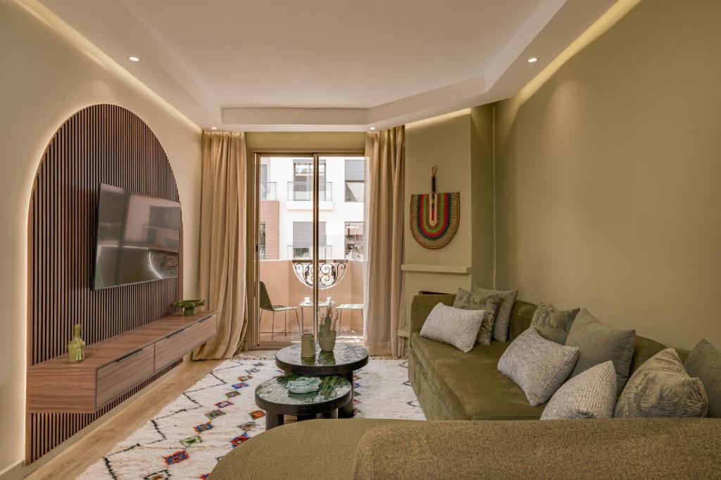 a living room with a couch and a table at GUELIZ Seven Stays in Marrakesh