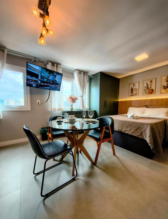 a room with a bed and a table and chairs at 1106 - Vila Germânica in Blumenau