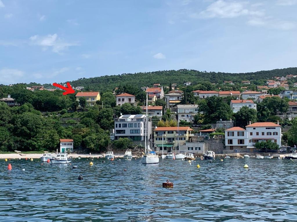 a group of boats in a body of water at Beach apartment Kostrena 2 in Kostrena