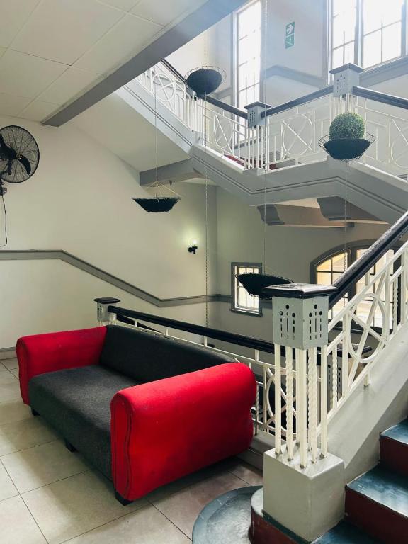 a living room with a red couch and stairs at Smith House in Durban