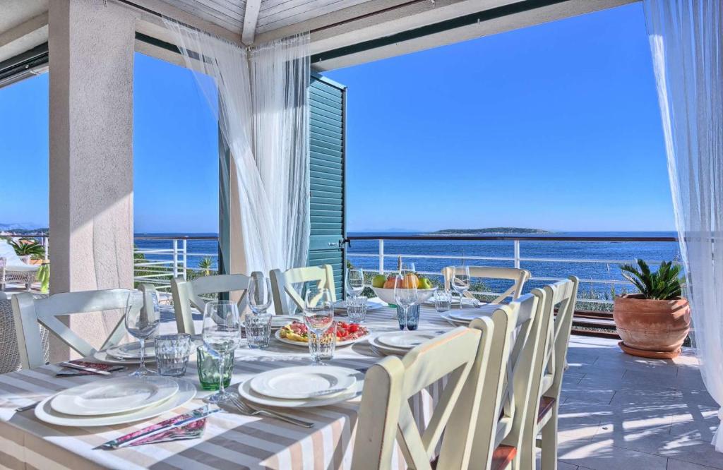 a dining table with a view of the ocean at Villa Tempera in Vis