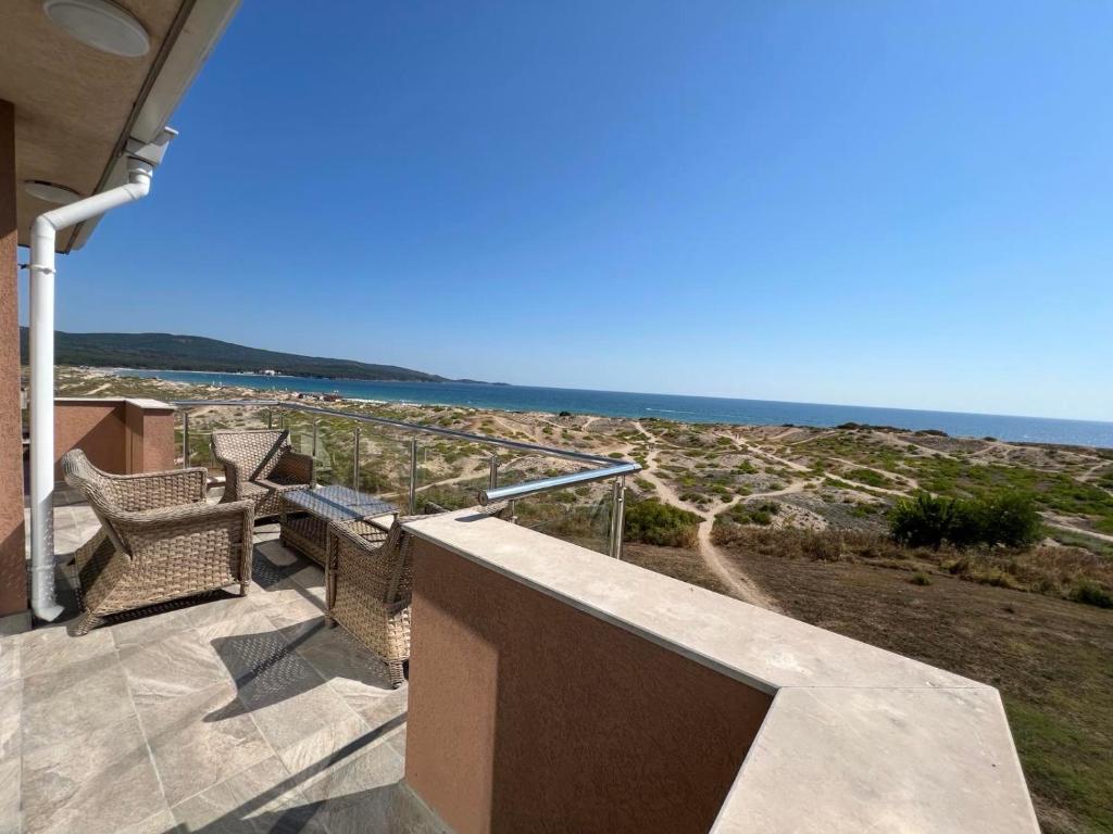 a balcony with chairs and a view of the ocean at Амон Ра 2 in Primorsko