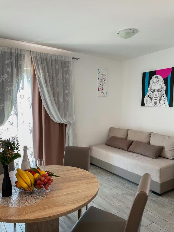 a living room with a table and a couch at Villa ARINA - Apartments 20 m from Beach, Tucepi in Tučepi