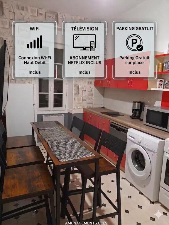 a table and chairs in a kitchen with signs on the wall at Sweet home in Cholet