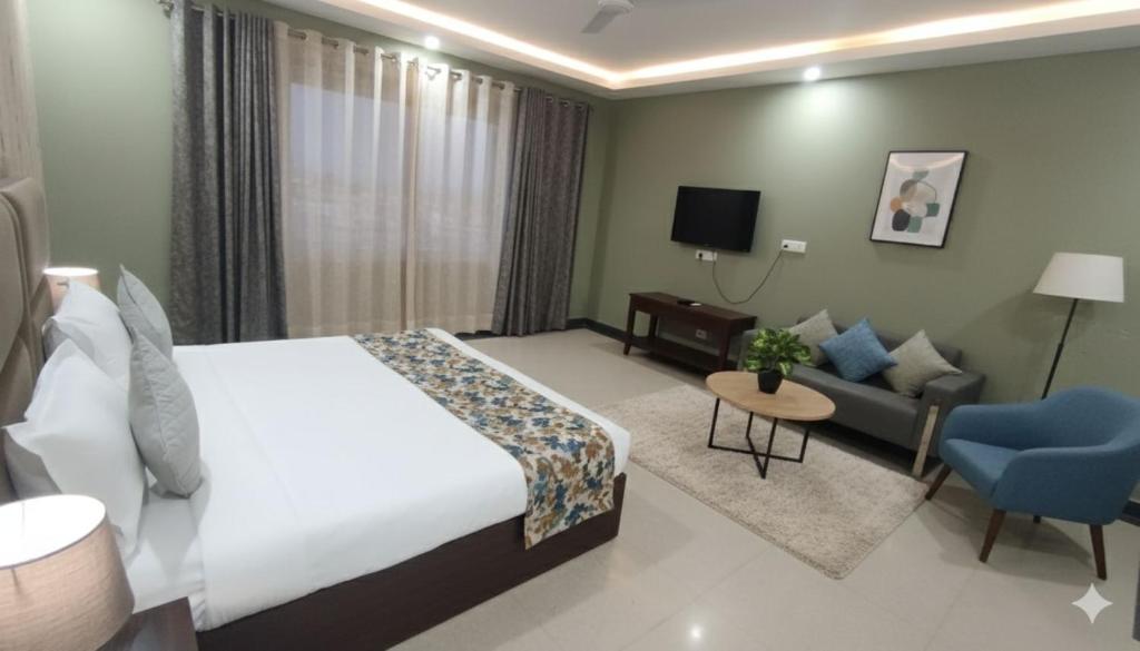 a hotel room with a bed and a couch at Hotel Loft Near IGI Airport Delhi in New Delhi