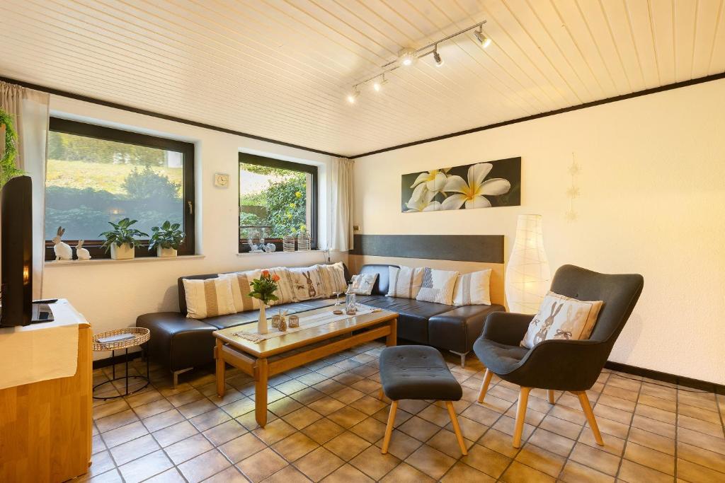 a living room with a couch and a table at Ferienwohnung Stork in Möhnesee