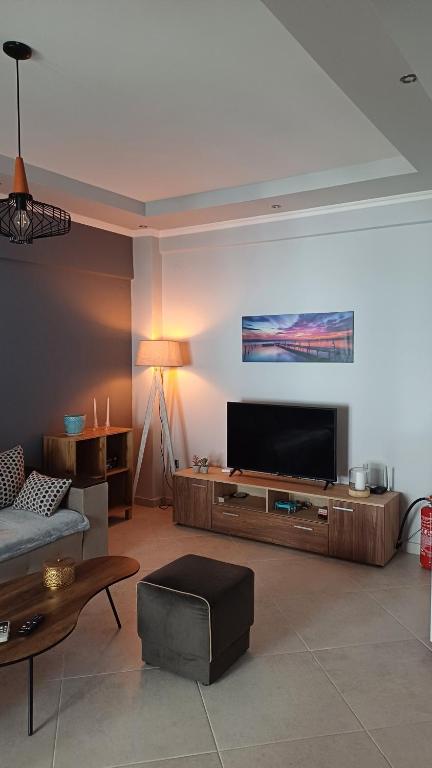 a living room with a large flat screen tv at Capital Apartment kilkis in Kilkis