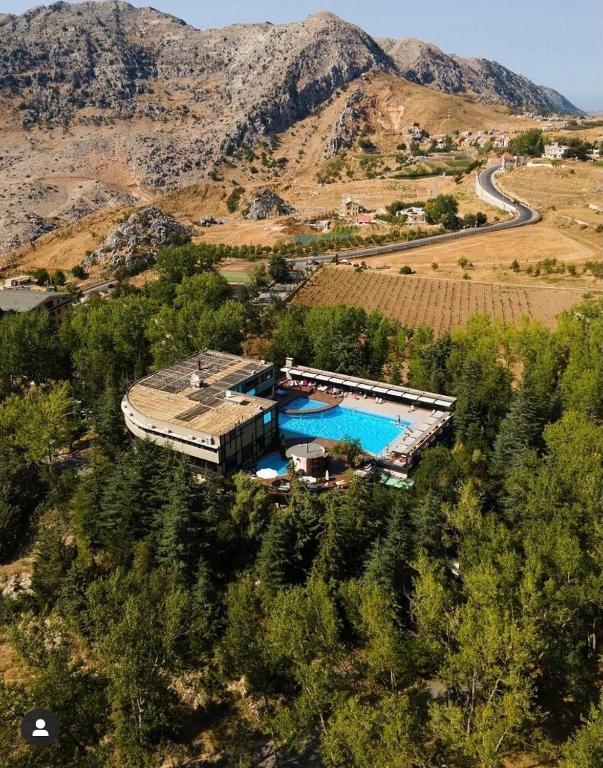 an aerial view of a house with a swimming pool at Laklouk Village Vacances in Jbeil