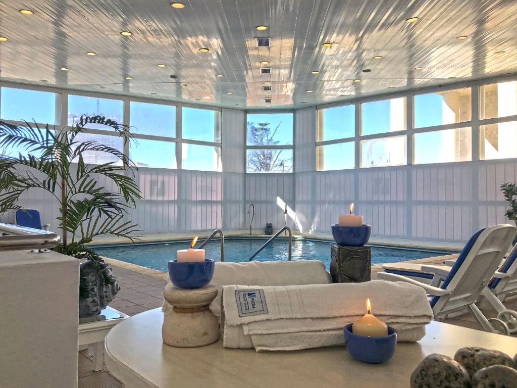 a living room with a swimming pool with candles on a table at Torres de Manantiales Apart Hotel in Mar del Plata