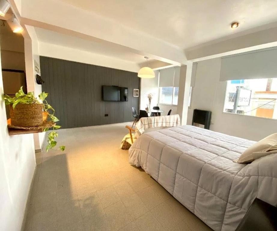 a bedroom with a large bed in a room at NuMa MAR in Puerto Madryn