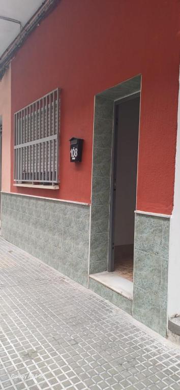 a building with a door and a number on it at Habitaciones turísticas copitos in Gandía