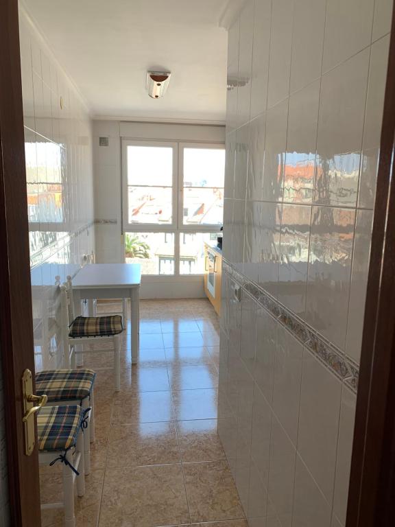 a room with a kitchen with a table and a window at Atalaya 5 - VUT5463AS in Ribadesella
