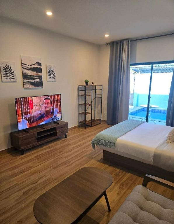 a bedroom with a bed and a flat screen tv at MSResort Panglao in Looc