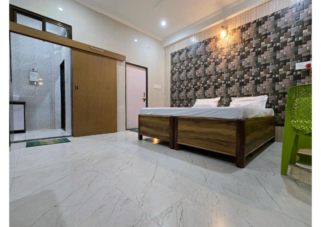 a bedroom with a bed and a brick wall at SHREE RAMA Niwasam in Ayodhya