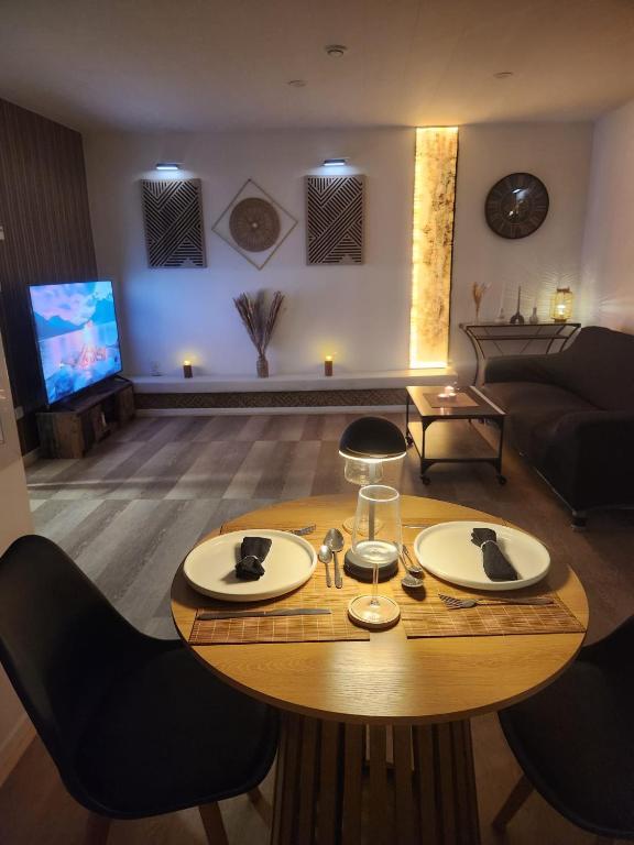 a living room with a table and a couch at Le Cocon Du Lac in Nantua
