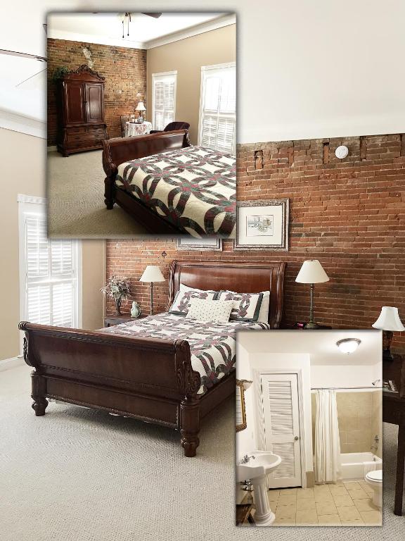 a bedroom with a bed and a brick wall at Eagles Nest Inn in Louisiana