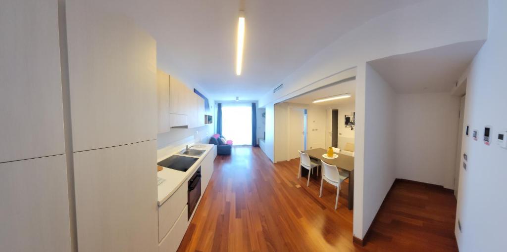 a kitchen and dining room with white cabinets and a table at Appartamenti Ariston - Centro Giulianova in Giulianova