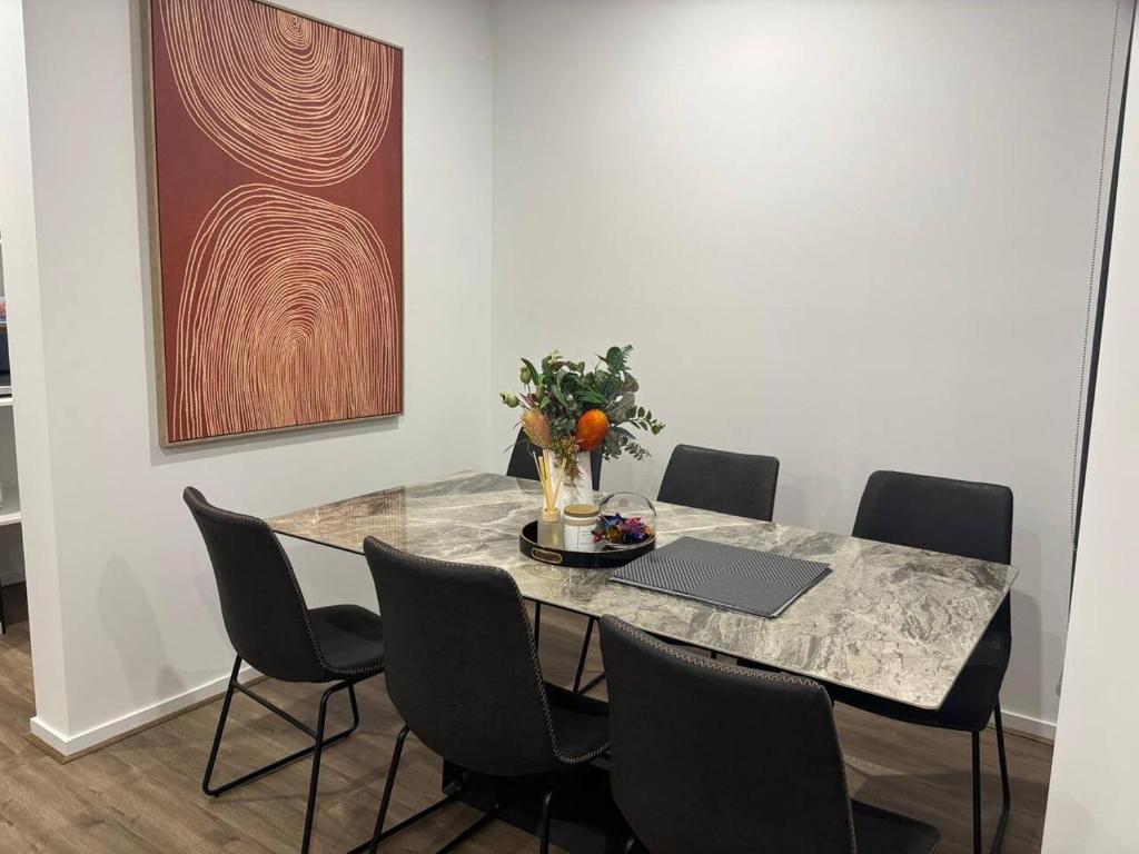 a dining room with a table with a laptop on it at Urban Pause - Donnybrook in Donnybrook
