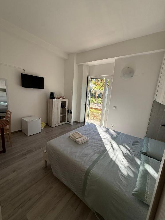 a bedroom with a bed and a sliding glass door at Alba & Tramonto in Levanto