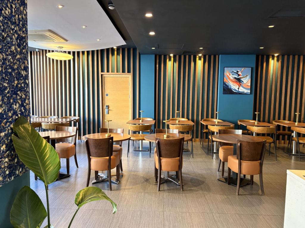 a dining room with wooden tables and chairs at Eurotraveller Hotel - Premier - Tower Bridge in London