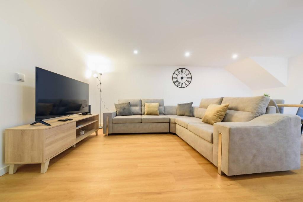 a living room with a couch and a flat screen tv at Santo Wellness Villa by Mth in Santo António da Serra