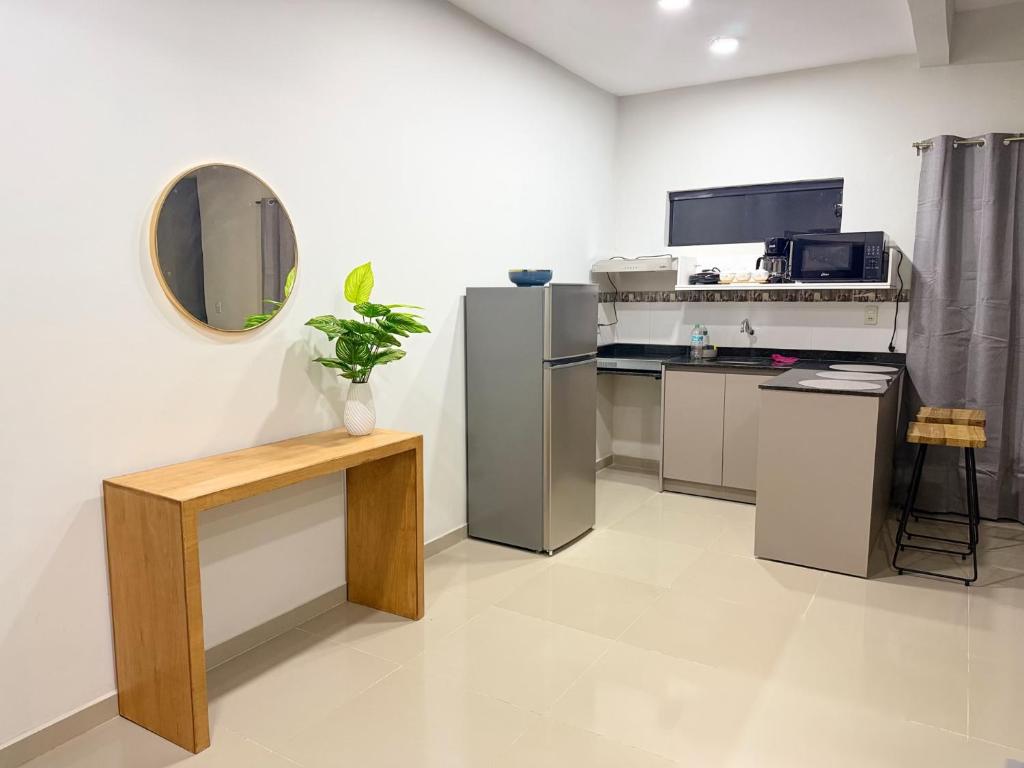 a kitchen with stainless steel appliances and a mirror at Duplex NR in Nu Guazu