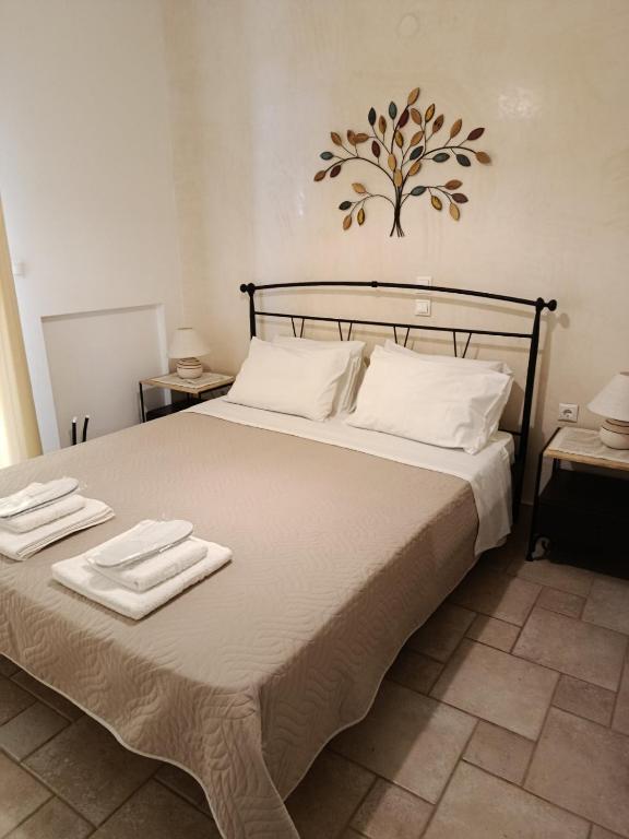 a bedroom with a bed with two towels on it at Vromolithos apartments in Nisís Léros