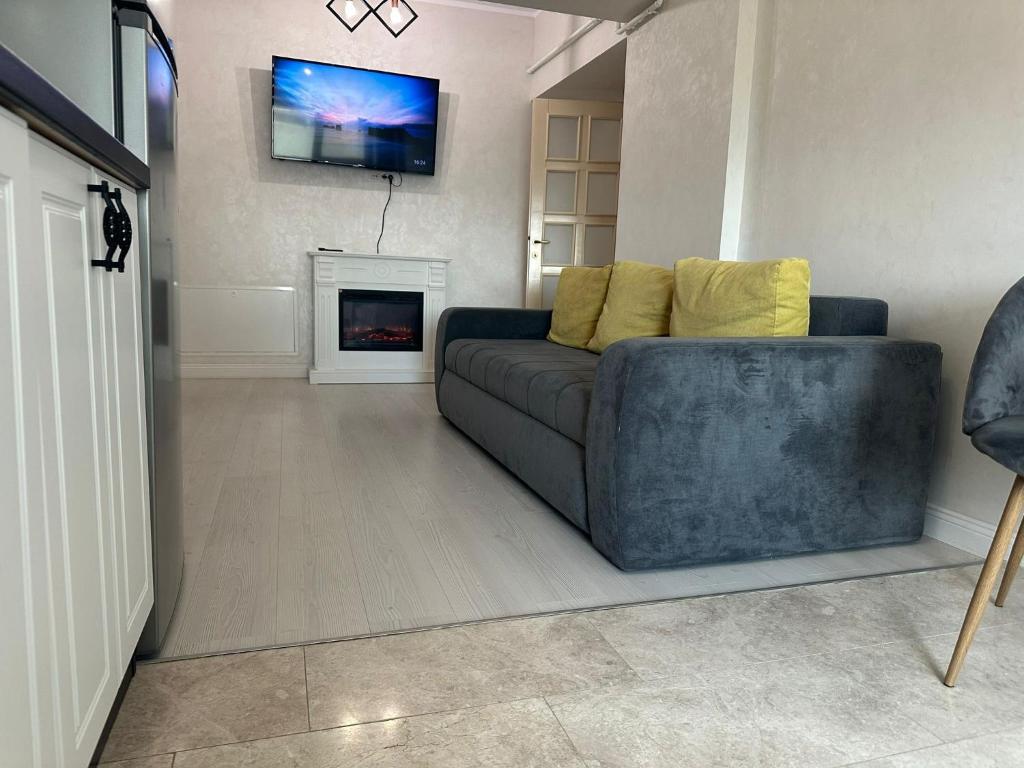 a living room with a couch and a fireplace at Fancy Bonjour - modern apartment in Iaşi