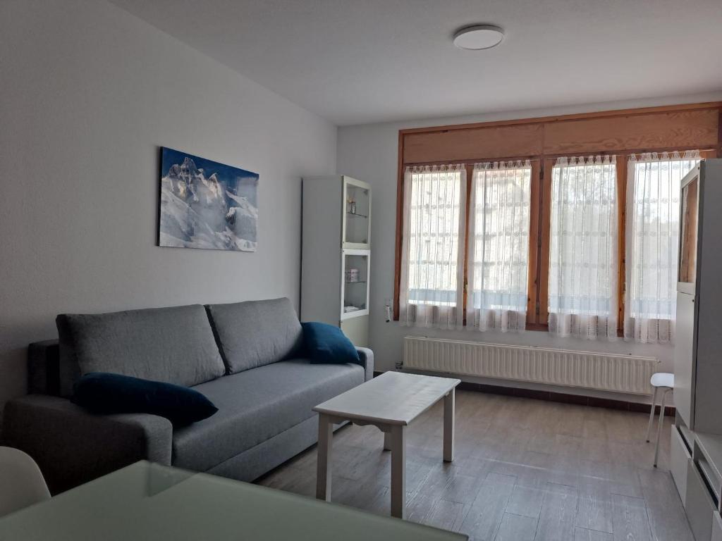a living room with a couch and a table at Apartamento Tilero, Parking incluido in Jaca