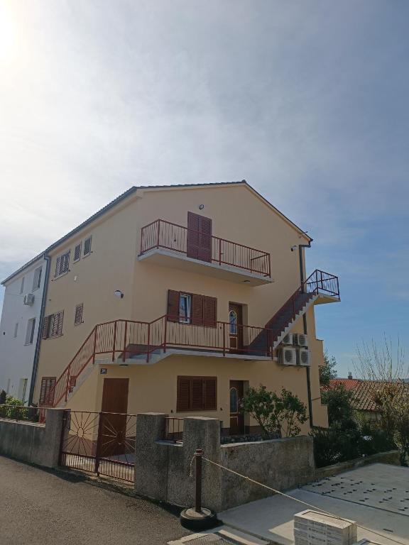 a building with stairs on the side of it at Apartmani Lili in Crikvenica