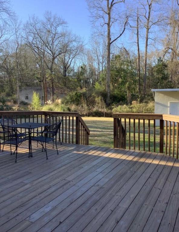 a wooden deck with a table and chairs on it at Lux Minimum 2 Lexington With Riverwalk & CAE in West Columbia