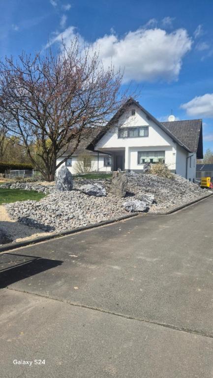 a house sitting on top of a pile of rocks at Ilo's Zimmervermietung in Stadtallendorf
