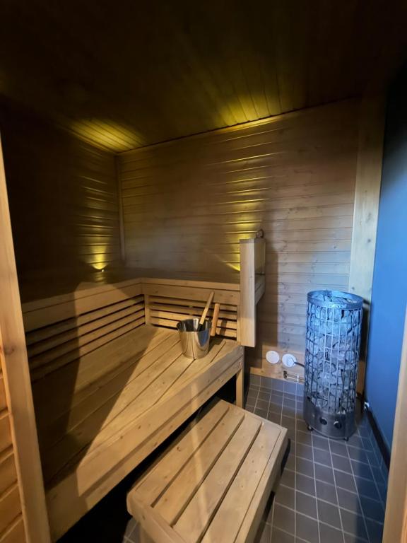 a sauna with a wooden bench in a room at Apartment Koivikkotie in Savonlinna