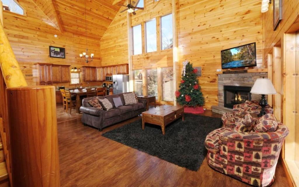 a living room with a christmas tree in a cabin at Lovely Platog Chalet with jacuzzi in Morzine