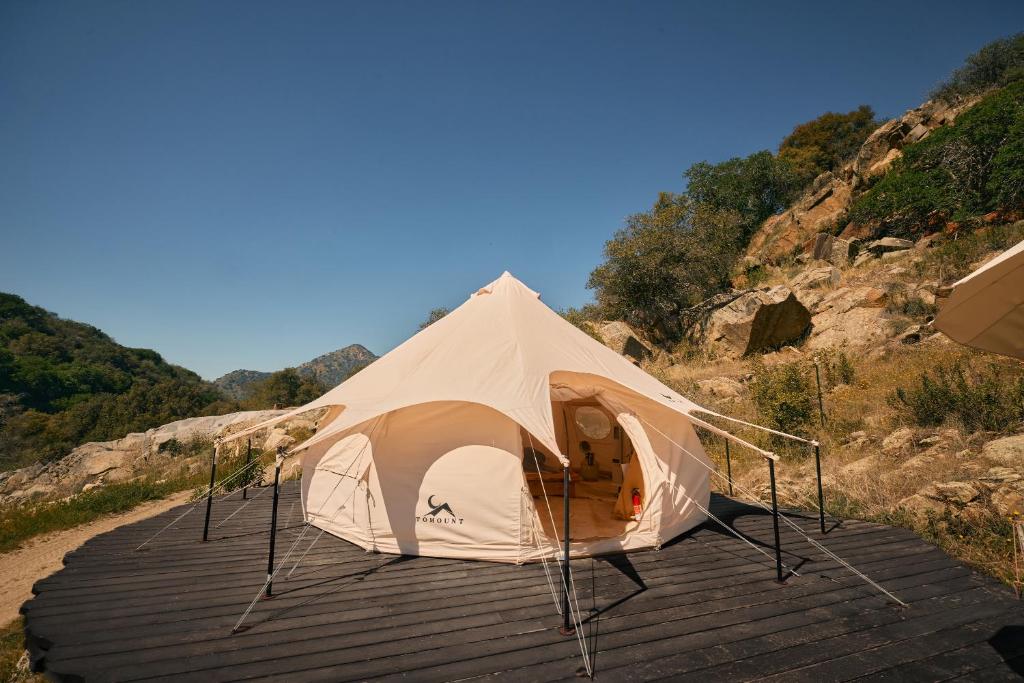 a white tent sitting on a wooden deck at Paradise Ranch Inn - Ecstatic Tent in Three Rivers