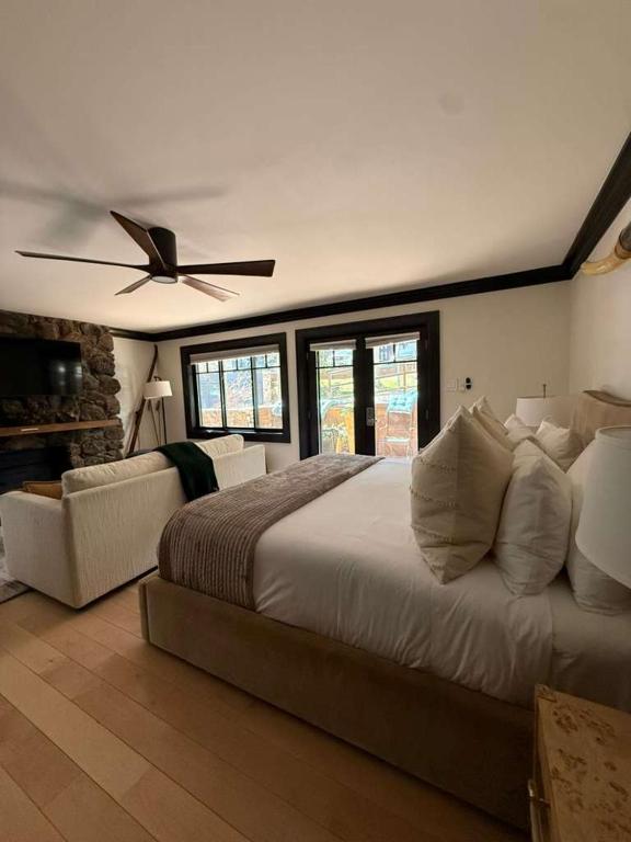 a bedroom with a large bed with a ceiling fan at Spacious 3 & 3 in Aspen's Core with Sauna in Aspen