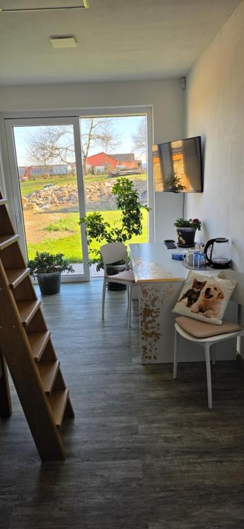 a room with a kitchen with a table and a staircase at Útulný klidný pokoj B in Radošovice
