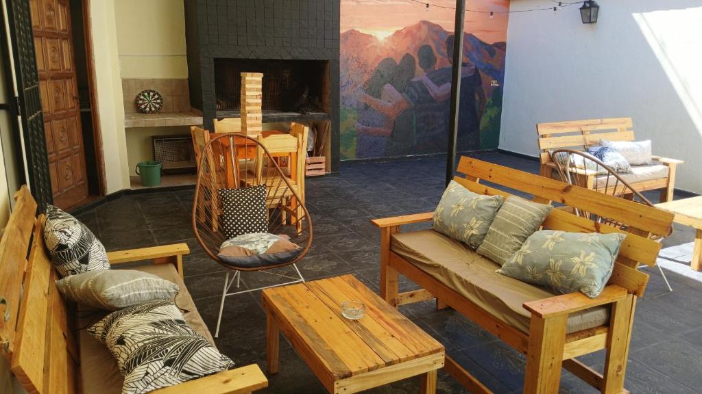 a living room with wooden furniture and a fireplace at MillaUno Hostel in Córdoba